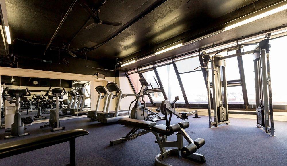 Hotel Stamford Grand Adelaide Glenelg Esterno foto The photo shows a modern gym interior with large windows that provide natural light. The space features various exercise equipment, including treadmills, a weight machine, and a multi-purpose bench. The flooring is carpeted, and the overall decor is 